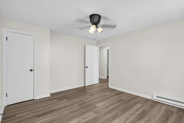 Upgraded space with modern fixtures, lighting, paint, and flooring installation by Rasnic Home Pros.