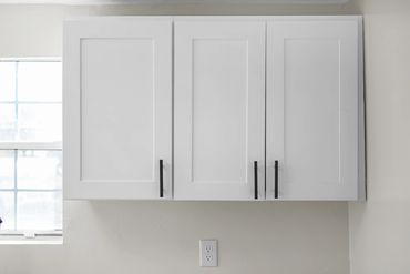 Cabinet installation in investment property renovation by Rasnic Home Pros.