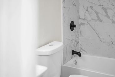 Rental property bathroom remodel by Rasnic Home Pros with modern fixtures and tile installation