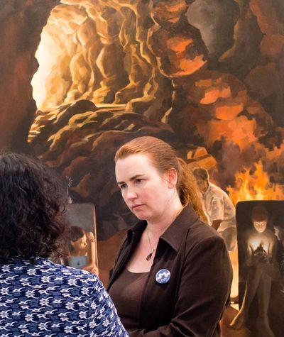 Lalita discussing her oil painting 'Plato's Cave' at an exhibition in Guiyang, China. Ted Nodwell