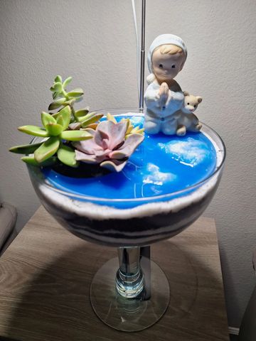 Succulent planter gift with a boy on his knees praying.