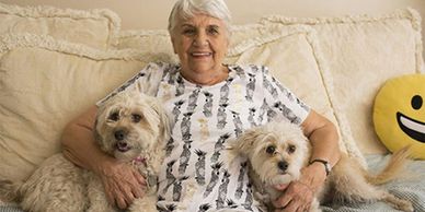 An elderly woman with two dogs
