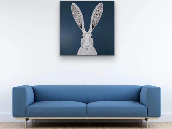 blue sofa and the rabbit painting on the wall