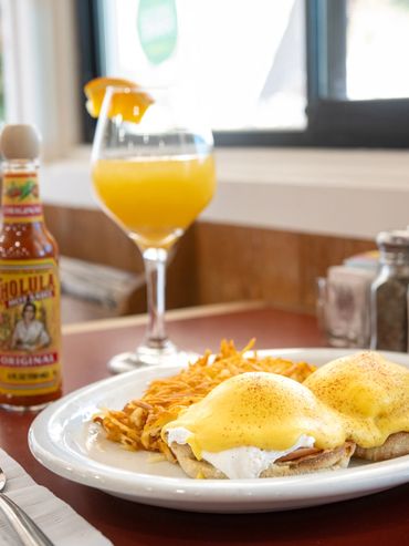 Two-Egg Benedict with hashbrowns, Cholula hot sauce and orange mimosa
