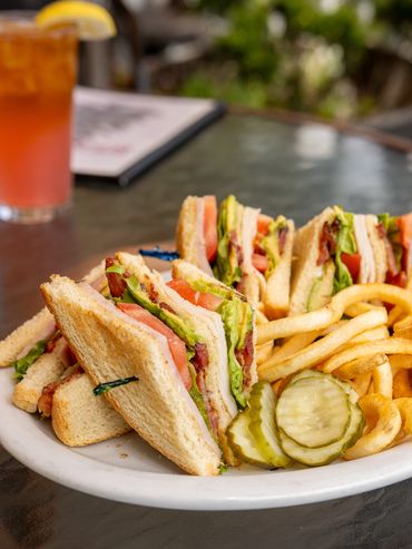 Large club sandwich with curly fries