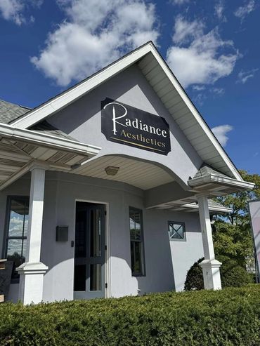 Exterior of Radiance Aesthetics clinic with blue sky.
