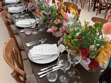 Elegantly set dining table with floral centerpieces.