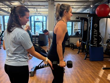 41-year-old mom strength training with dumbbells at Top Shape Charleston for tone and confidence.