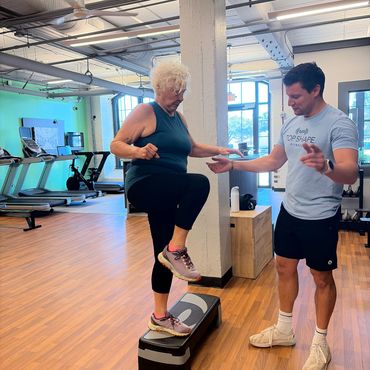 Charleston senior women balance training session with personal trainer at Top Shape Fitness gym.