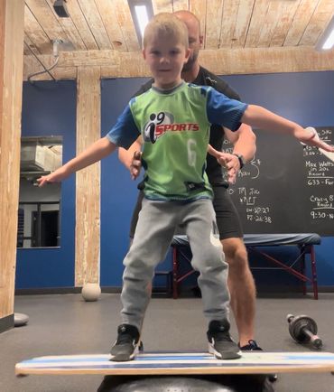 Youth doing balance and coordination training for core strength at Top Shape Fitness Charleston.