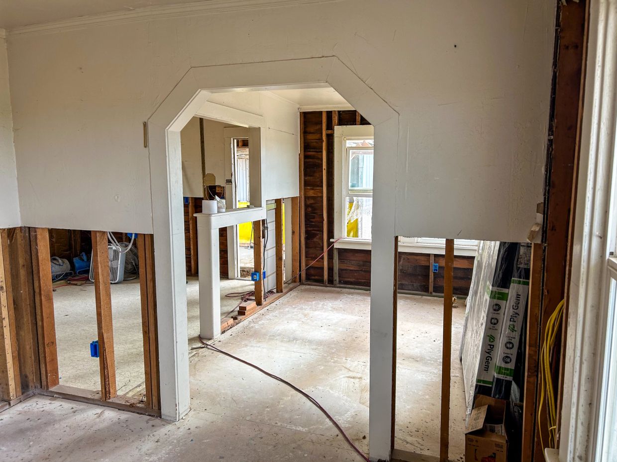 Crows Landing CA remodel demo by Cordeiro Custom Remodeling — stripped framing, arched doorway, expo