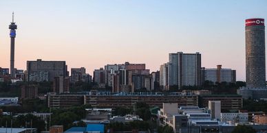 City skyline with tall buildings during sunset.