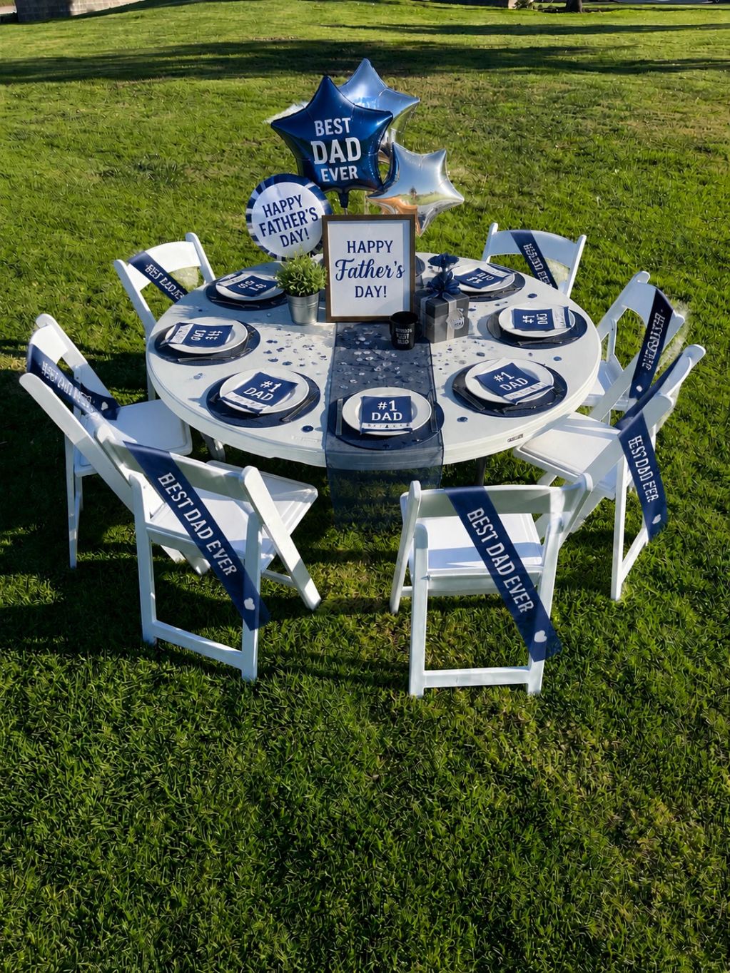 Outdoor Father's Day celebration setup with themed decorations and seating.