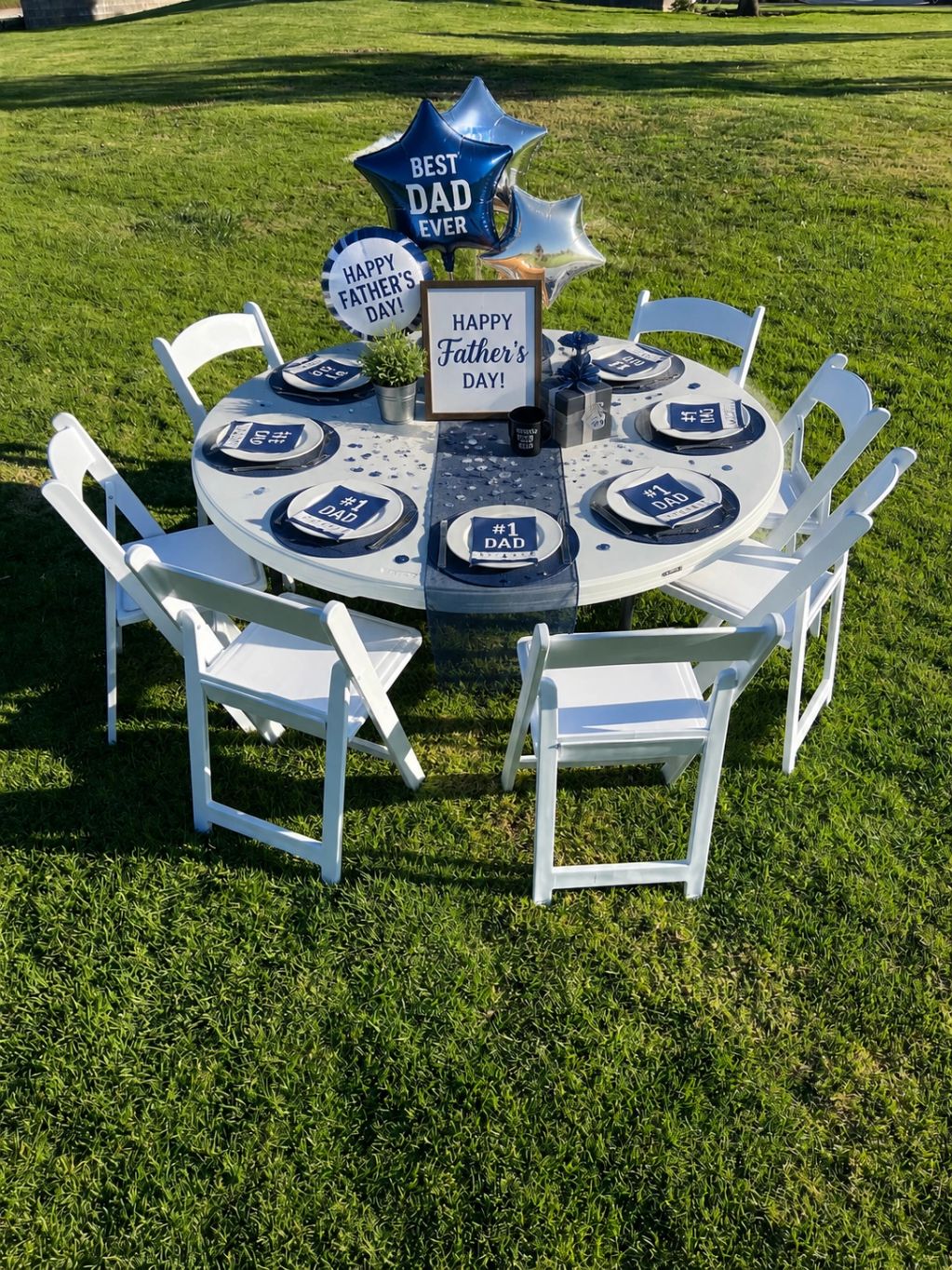 Outdoor Father's Day table setup with balloons and #1 Dad napkins.