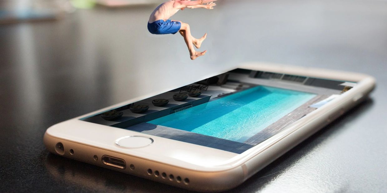 Boy jumping into pool on smartphone screen.