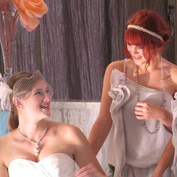 Bride and bridesmaid chatting and smiling