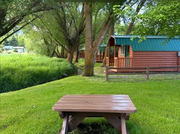 Camper cabins with picnic bench near creek and natural beauty