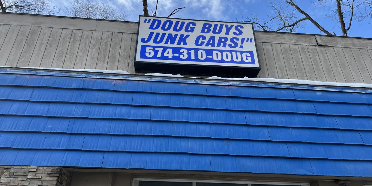 The Doug Buys Junk Cars sign in Mishawaka.