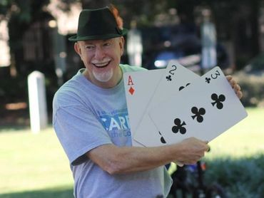 JIm performing magic at a festival