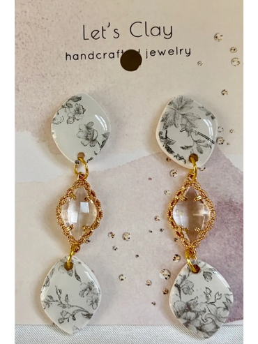 Elegant handcrafted earrings with floral designs and gold accents.