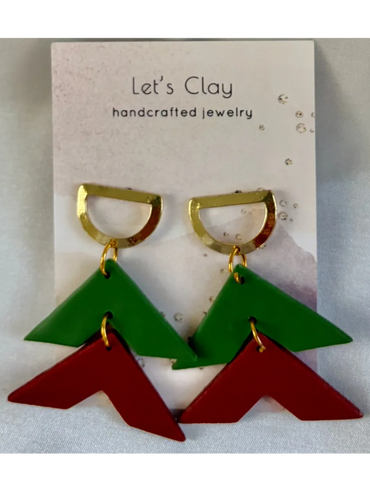 Colorful geometric clay earrings with gold accents on a branded card.
