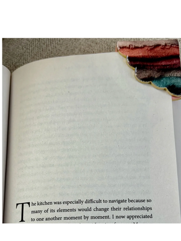 A book page with a colorful scalloped bookmark at the top right corner.