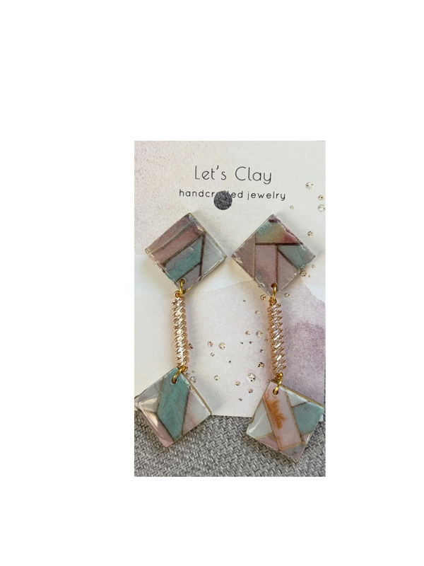 Geometric handcrafted clay earrings with pastel colors and gold accents.