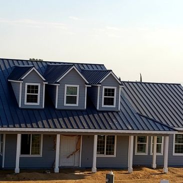 New blue house with a metal roof.