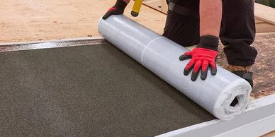 Rolling out ice & water shield on the eaves.