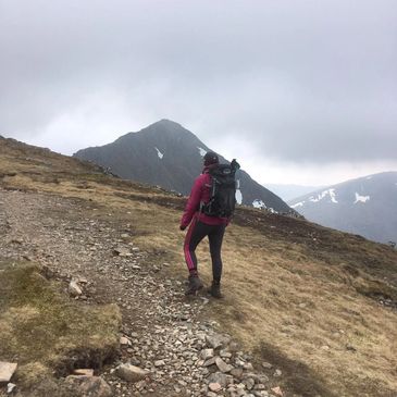 Woman hiking up a mountain