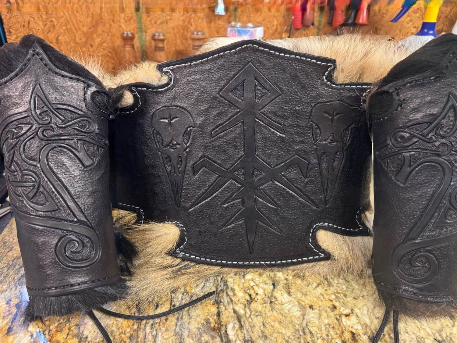 Black custom leather armor with intricate Viking-inspired designs and fur trim.