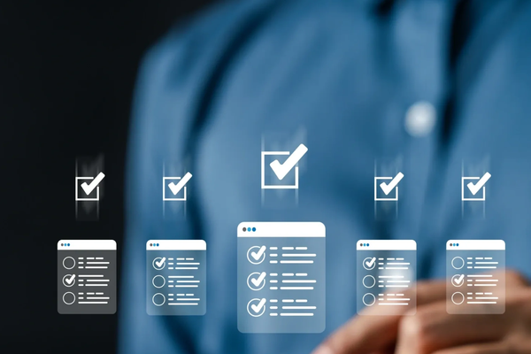 Digital checklists with check marks floating above a person's hand in a blue shirt.
