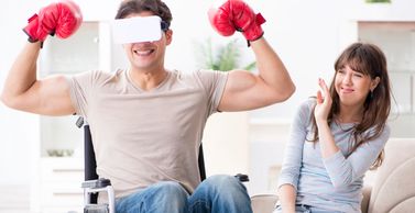 A male boxer in a wheelchair wearing a virtual reality headset