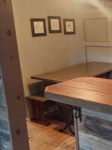 Cozy rustic kitchen with wooden counter and bench seating.