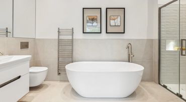 Modern bathroom with a freestanding bathtub and glass shower.