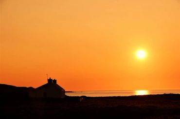 Traigh Cottage at sunset on Islay