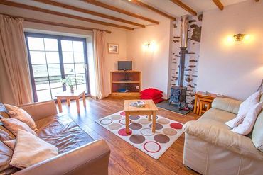 Living room in Muran beach cottage with view of sea