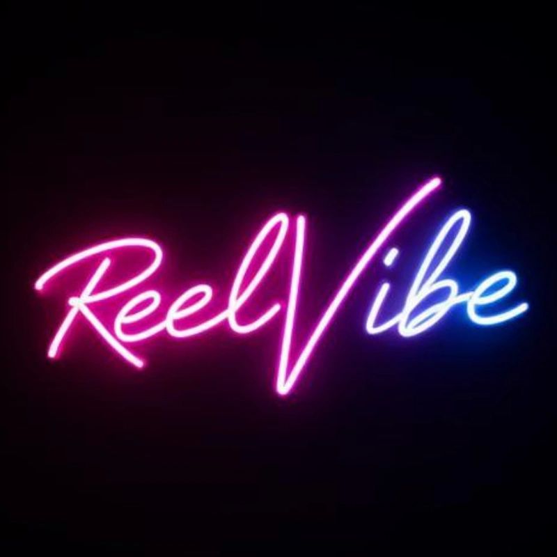 Neon sign displaying the words 'Reel Vibe' in glowing pink and blue colors.