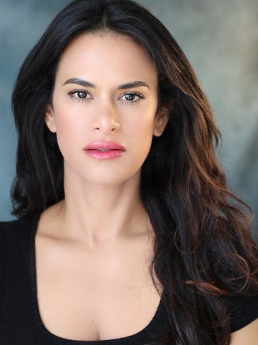 Portrait of a woman with long dark hair and a black top.