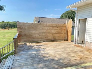 Photo of a wooden deck after washing and stripping in preparation for staining.