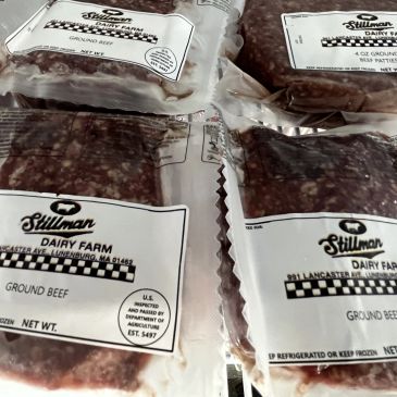 Packages of Stillman Dairy Farm ground beef stacked together.