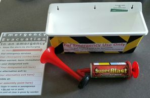 A laminated emergency evacuation procedure, a container for the wall and a superblast pump air horn.