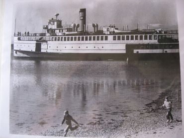 Two Boys racing the last steamship in Lewis Bay. 1963 image Bay View Beach, Creek in Hyannis Park.