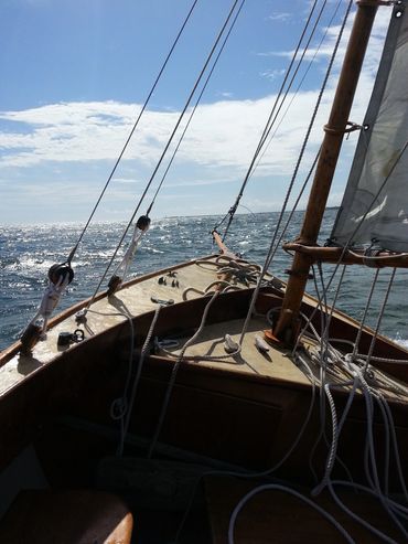 Reaching into the wind, wooden cutter rig sloop off Hyannis Port.