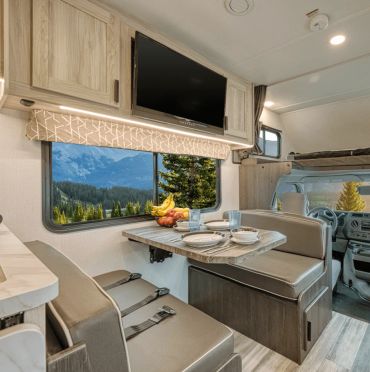 Cozy RV dining area with mountain view.