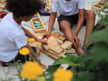 two boys working together to build a tower