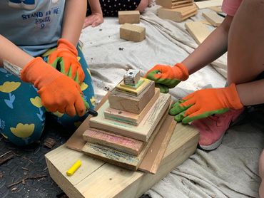 a wood birthday cake. children using their imagination to repurpose wood