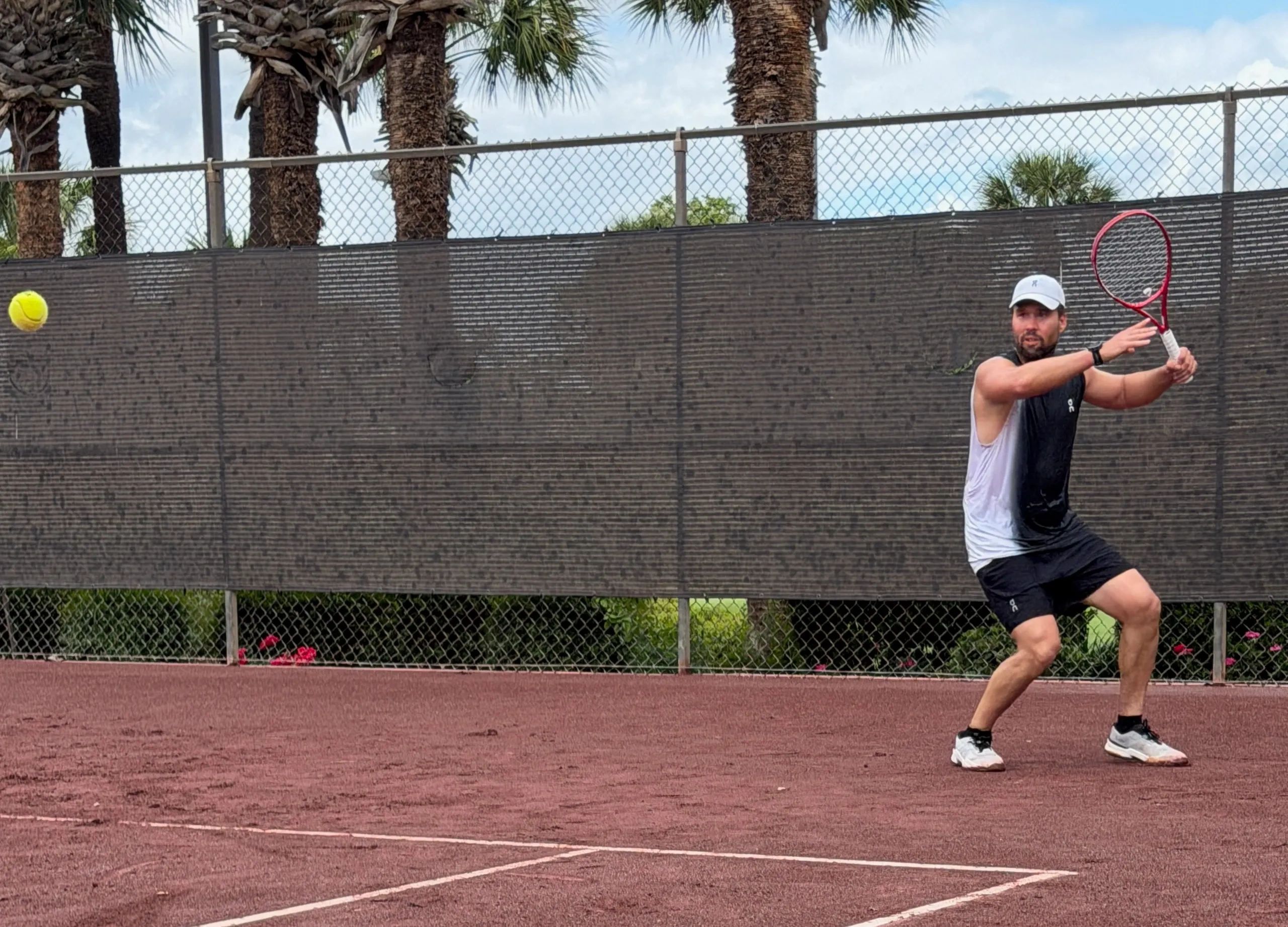 Tennis coach Arnold Lovera hitting tennis ball with proper form and technique
