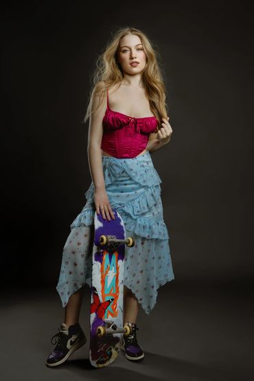 woman artist holding a skateboard