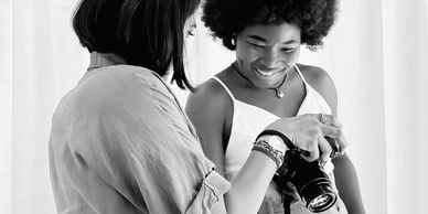 Trish boudoir photographer showing client her image